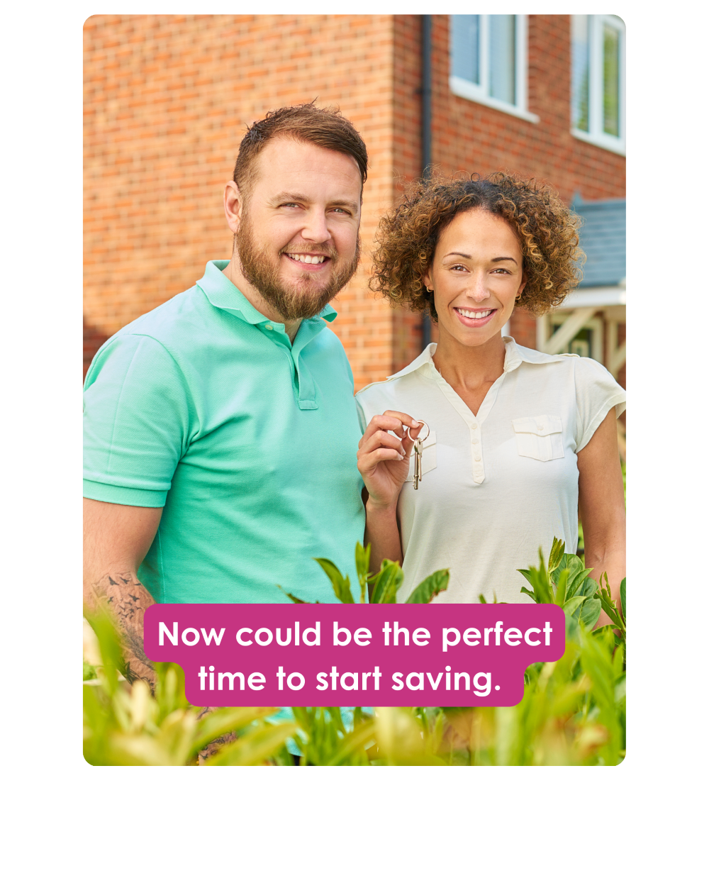 Happy home buyers holding keys outside their new home