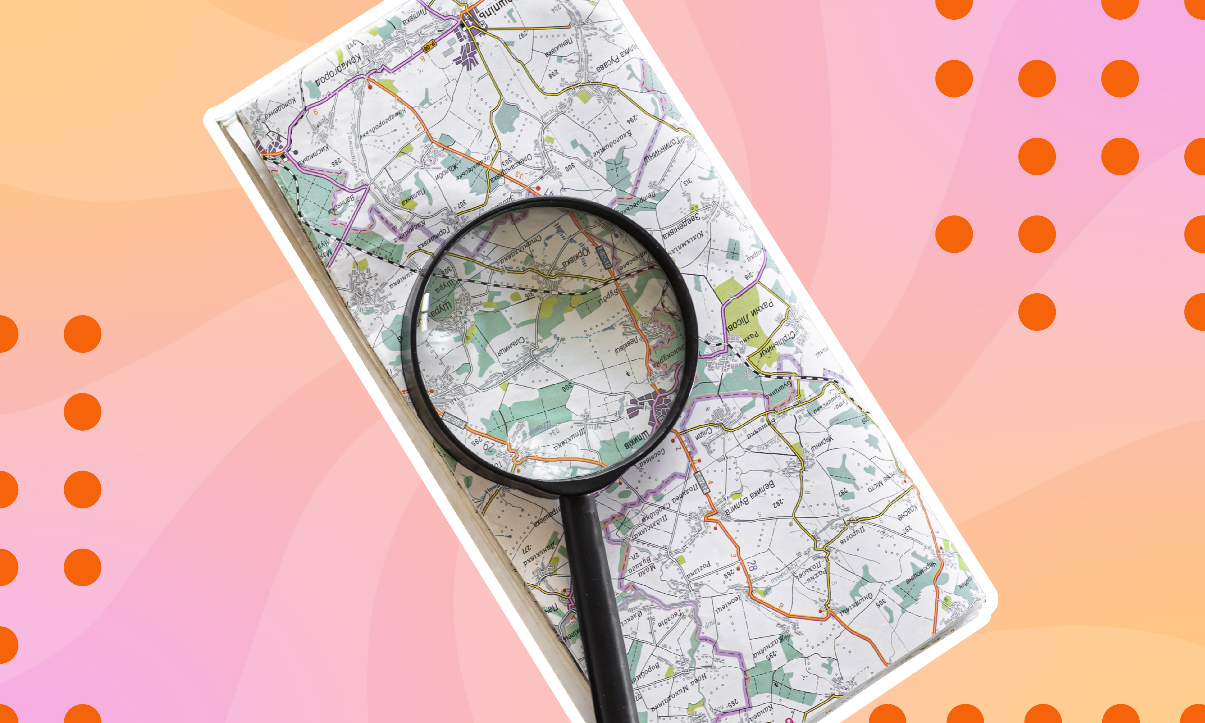 Image is of a road map with a magnifying glass