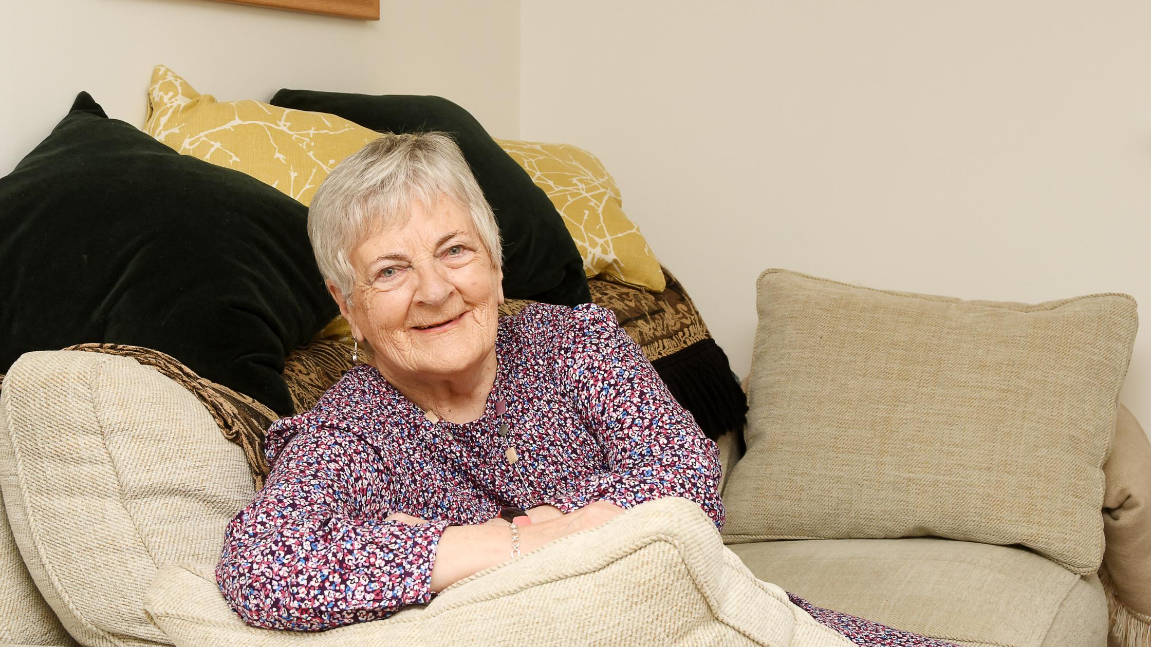 Mary sat on her sofa
