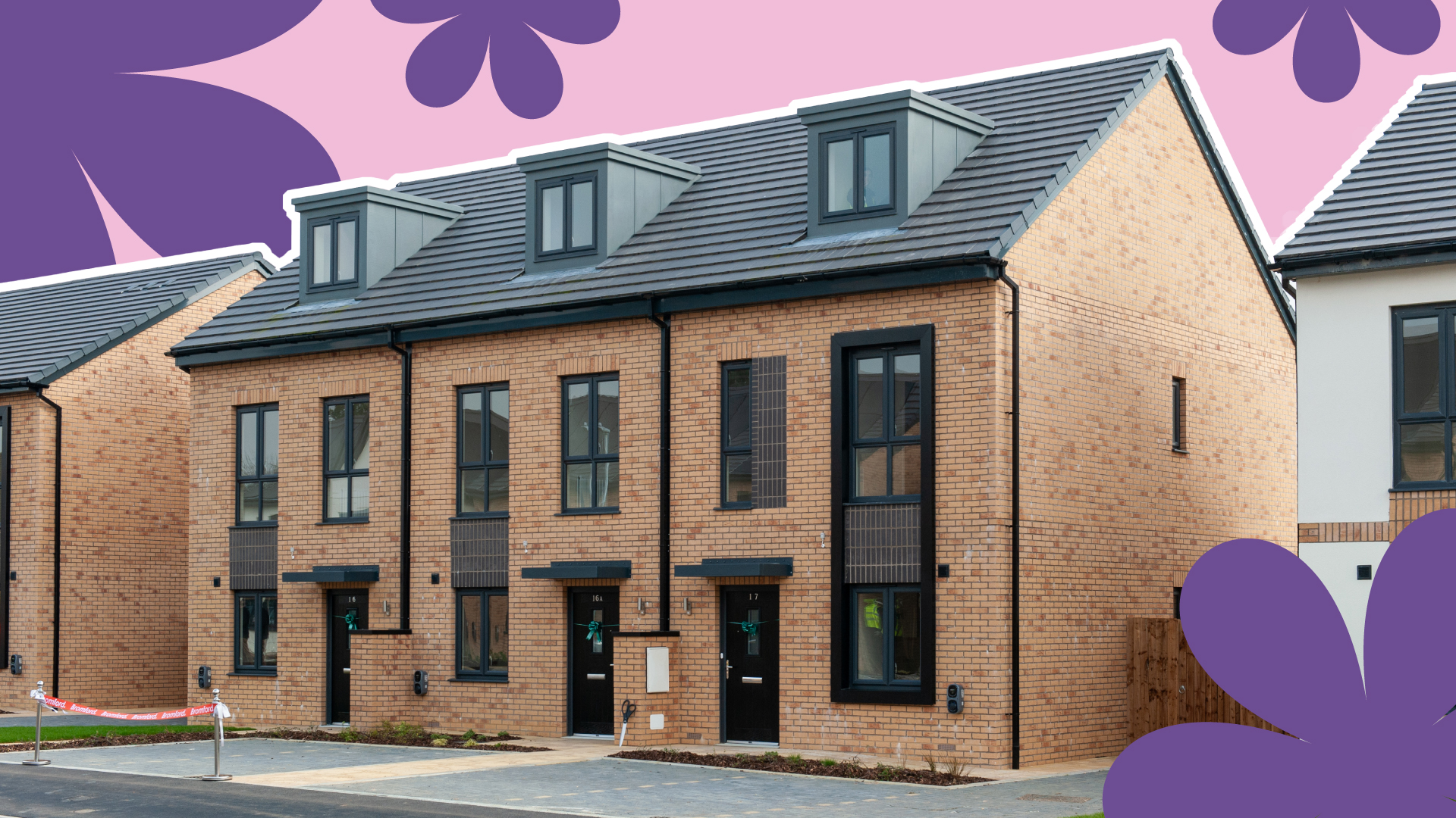 Row of three-storey new-build brick townhouses with dormer windows, black front doors and private parking spaces.