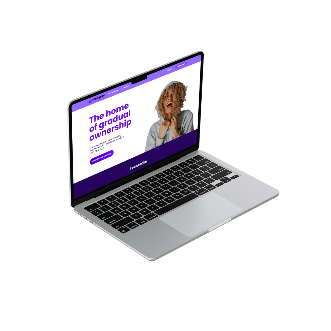 Image of an open laptop showing the Stairpay homepage on its screen.