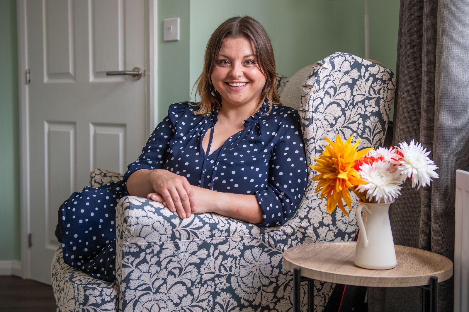 Anna sitting in a wingback chair