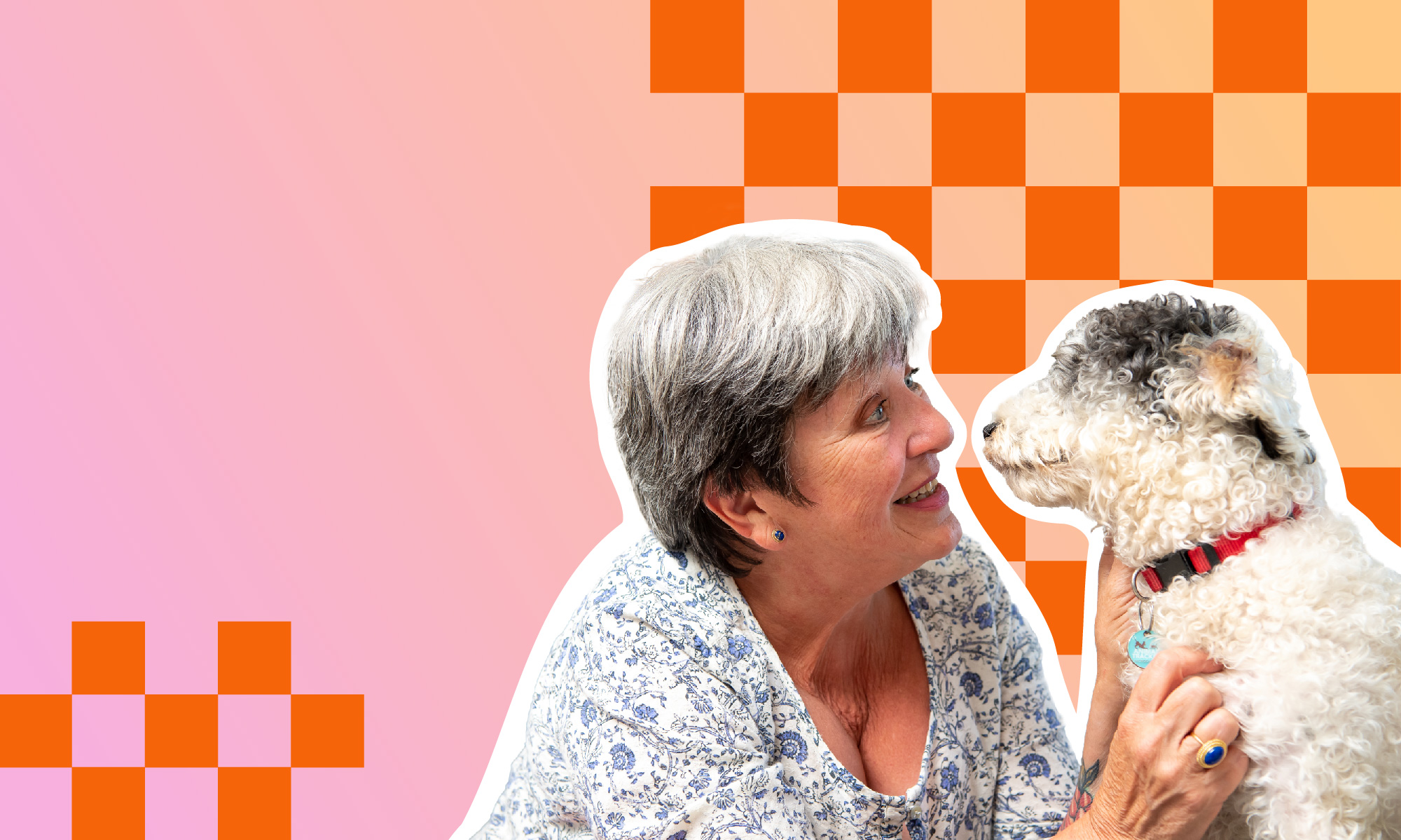 Woman smiling at a white dog against a pink and orange patterned background.
